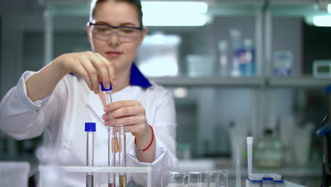 Female-scientist-working-in-chemical-laboratory.-Scientist-close-test-tubes